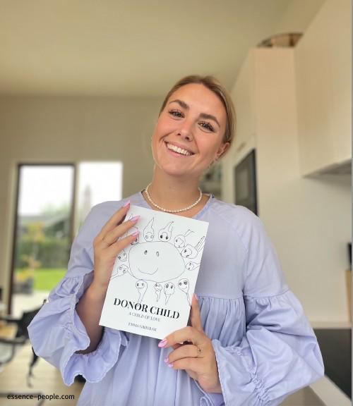 Emma Groenbaek holding her book